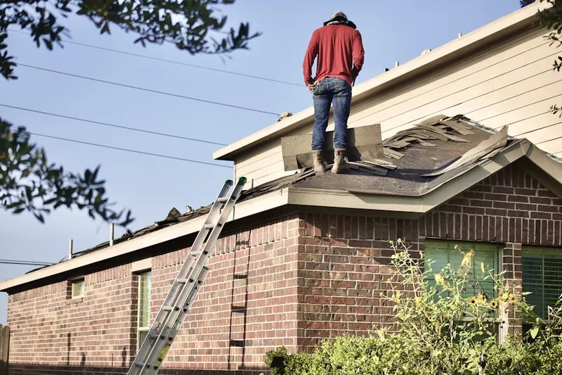 Professional roofer working on a residential roof in The Grove